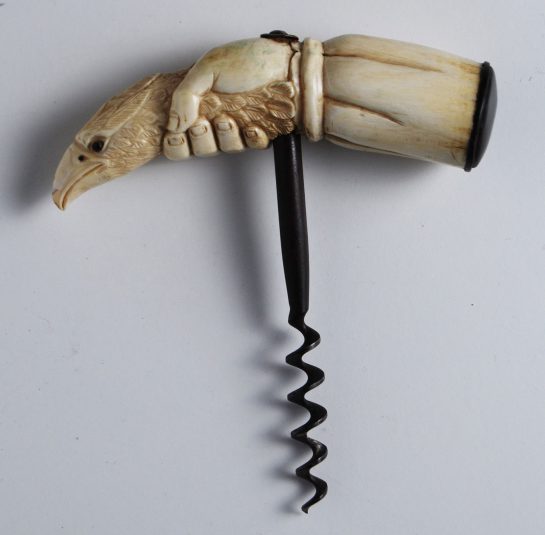 Whale Tooth carving of a Hand holding the Head of an Eagle