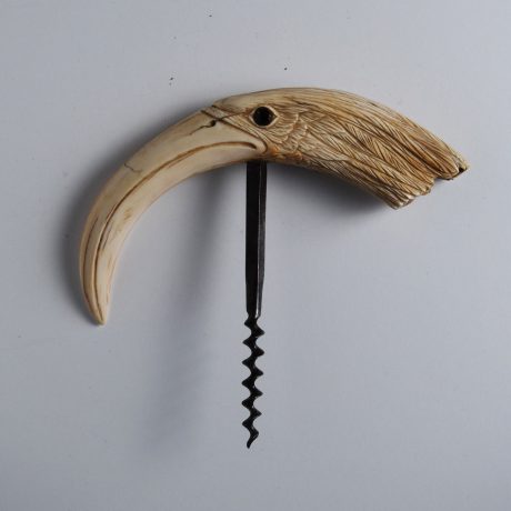 A Boar Tusk carved into the head of an Egret or a Heron