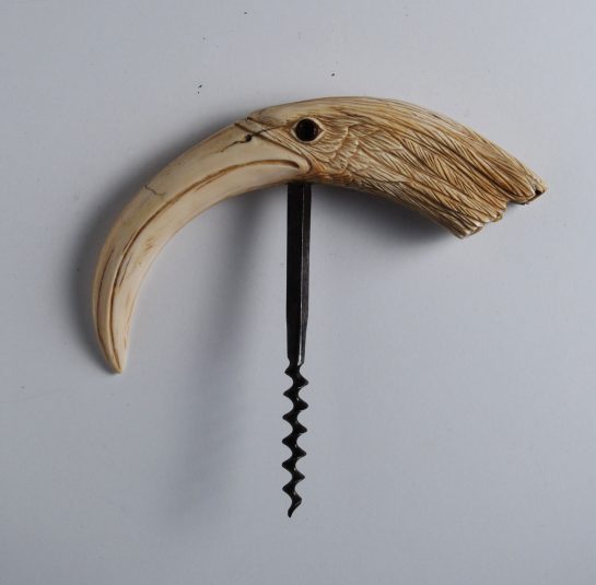 A Boar Tusk carved into the head of an Egret or a Heron