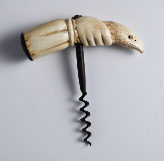 Whale Tooth carving of a Hand holding the Head of an Eagle