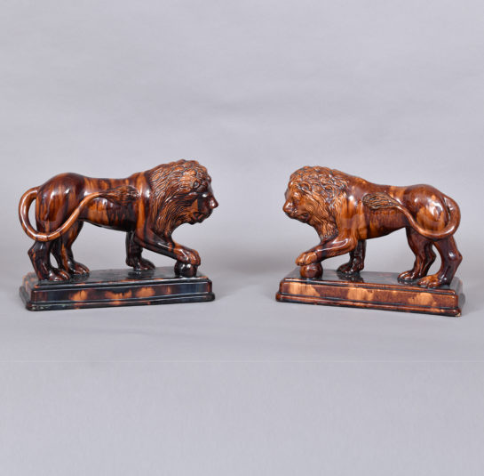 Pair of Rockingham-Glazed Lion Figures